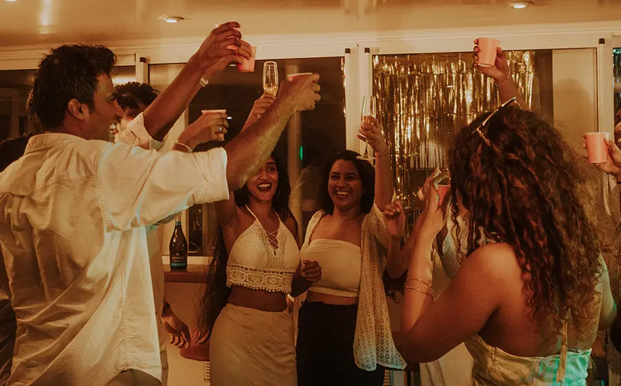 Group celebrating a milestone on a private catamaran